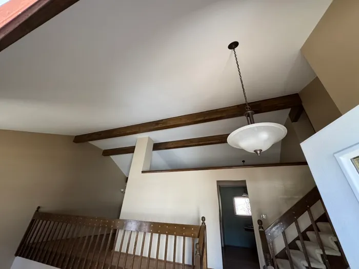 Same ceiling finished and painted between the beams